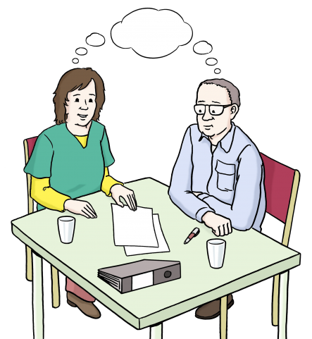 Auf dem Bild sieht man einen Mann und eine Frau an einem Tisch sitzen. Gemeinsam erarbeiten sie ein Thema
